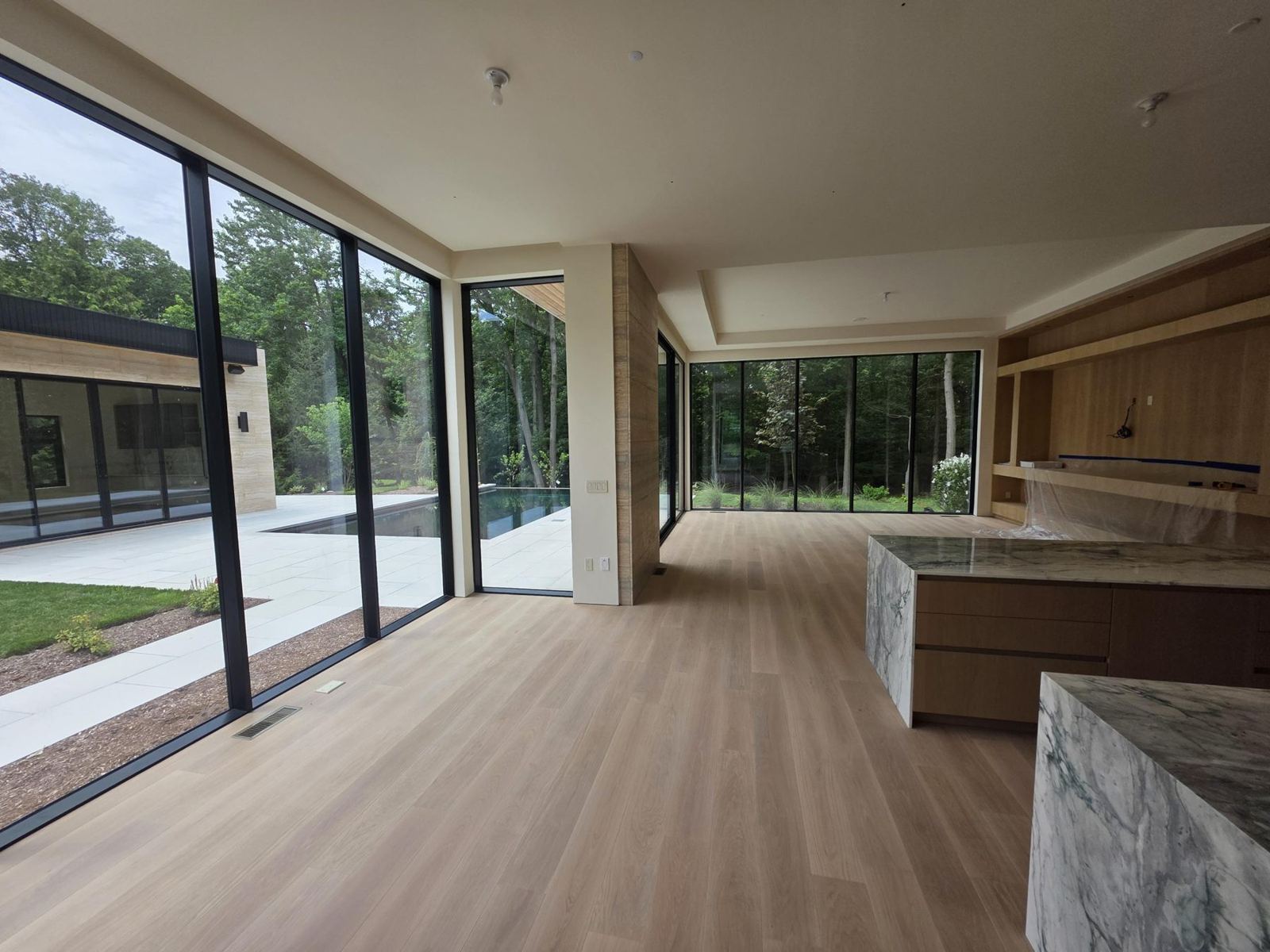 Modern kitchen with waterfall island and floor-to-ceiling glass