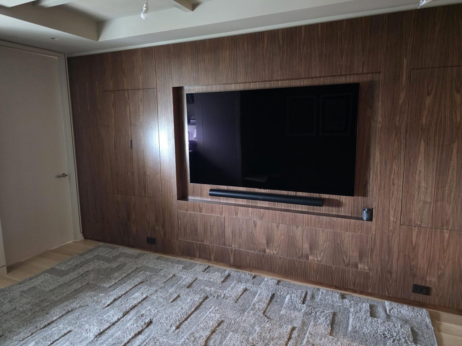 Walnut media wall with recessed TV niche and soundbar